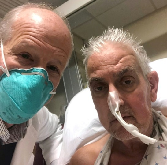 In this photo released by the University of Maryland School of Medicine on Jan. 10, 2022, Dr. Bartley Griffith (left) and David Bennett (right), who received a pig heart transplant at Baltimore UNIVERSITY OF MARYLAND SCHOOL OF MEDICINE/AFP